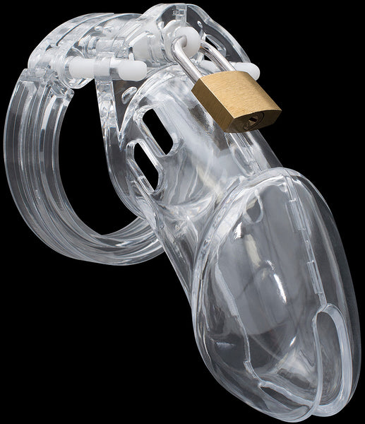 Clear HoD600 male chastity device made of plastic with white side pins and a brass padlock attached to a central white guide pin at the top of the cage. The kit is against a black background.