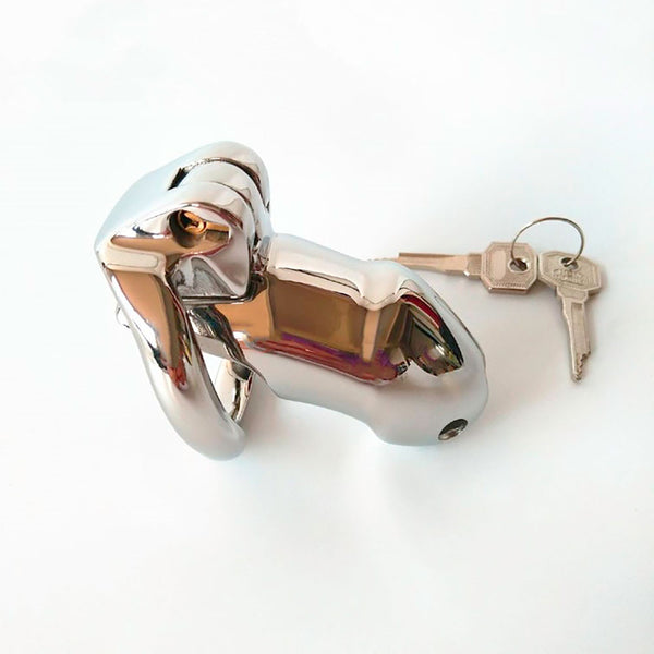 Side view of a stainless steel Holy Trainer V2 chastity device next to a set of metal keys.