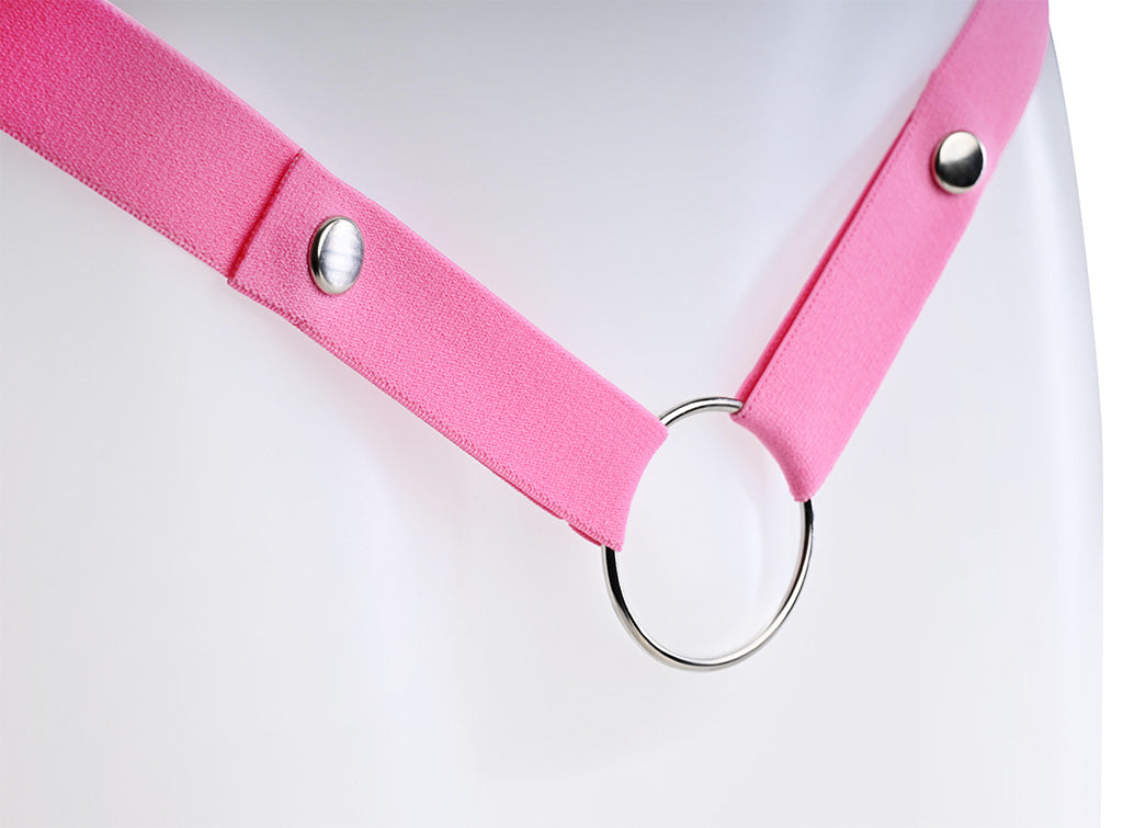 Close up of the popper buttons and metal o-ring on the pink strap.