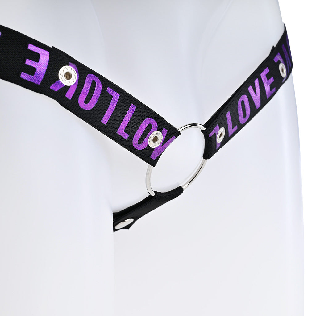 Close up of the black strap with purple love text attached to a metal o-ring.
