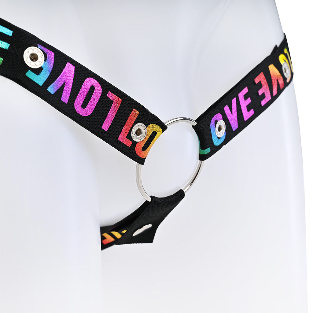 Close up of the black belt with rainbow love around the band with a metal o-ring on a mannequin against a white background.