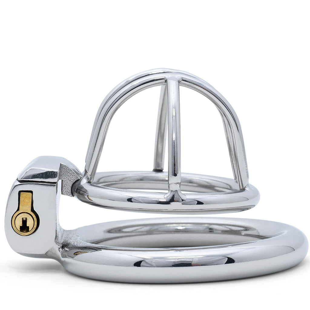 A polished metal adult novelty item with a curved small cage size top and circular back ring, photographed on a clean white background.