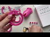 Putting together the back ring and pink plastic cage then locking the padlock to the central white pin.