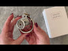 Attaching the medium size thimble shaped cage to the stainless steel circular back ring then inserting the brass lock.