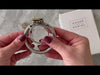 Attaching the flat front ring to the stainless steel circular back ring then inserting the brass lock.