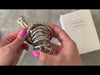 Attaching the large size metal cage to a hinged back ring then inserting the lock into the kit.