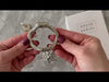 Attaching the hinged back ring to the metal cage then inserting the brass lock into the kit.