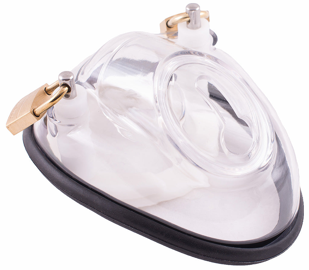 A clear plastic cock cup V1 male chastity device with a black rubber ring around the base, two brass padlocks on either side of attached to metal lock pins and a keyhole shaped urination hole opening on the top.